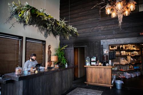 a man sitting at a bar in a restaurant at Campfire Hotel in Bend