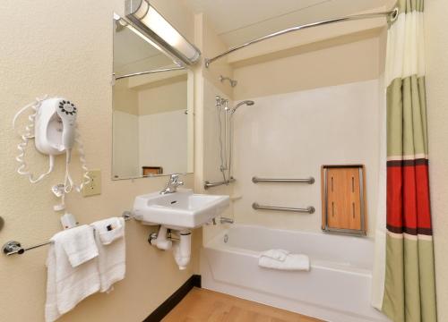 a bathroom with a sink and a tub and a shower at Red Roof Inn PLUS+ Secaucus - Meadowlands in Secaucus
