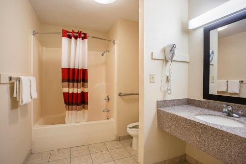 a bathroom with a sink and a toilet and a shower at Red Roof Inn West Memphis, AR in West Memphis