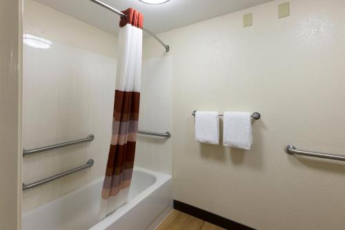 a bathroom with a shower and a bath tub at Red Roof Inn PLUS+ West Springfield in Springfield