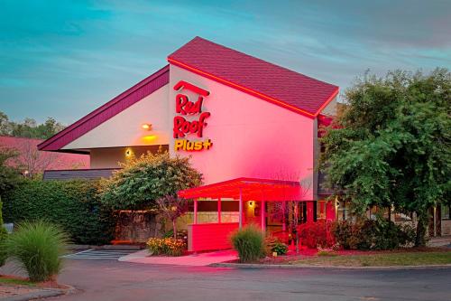 a red roofed restaurant with a red sign on it at Red Roof Inn PLUS+ West Springfield in Springfield