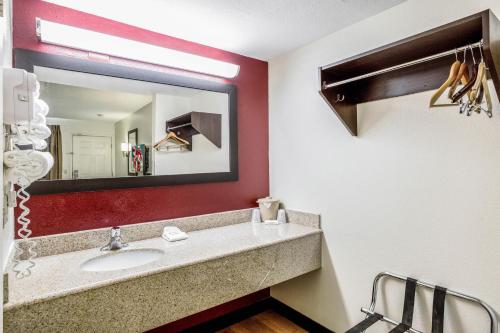 a bathroom with a sink and a mirror at Red Roof Inn Gallup in Gallup
