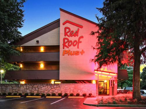a red rock plus building with a sign on it at Red Roof Inn PLUS+ Atlanta - Buckhead in Atlanta