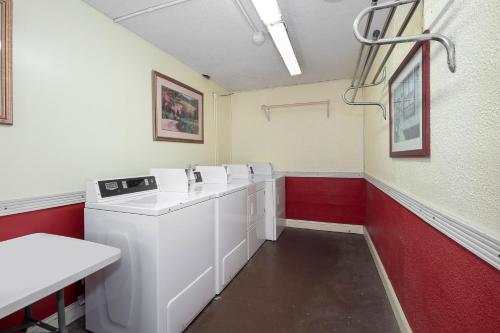 a laundry room with a washer and dryer at Red Roof Inn Murray in Murray