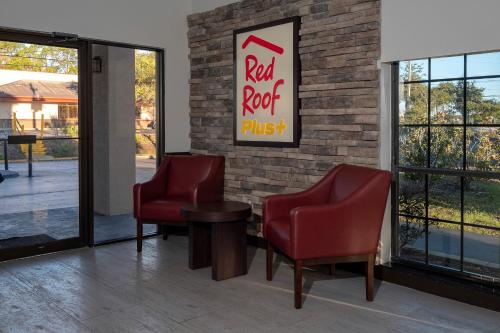 a waiting room with two chairs and a red roof plus sign at Red Roof Inn PLUS+ St. Augustine in Saint Augustine