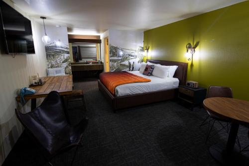 a hotel room with a bed and a table and chairs at Campfire Hotel in Bend