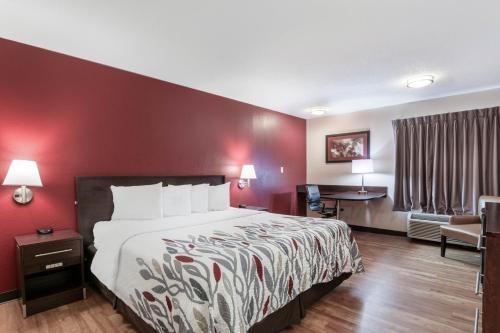 a hotel room with a bed and a desk at Red Roof Inn Richmond, KY in Richmond