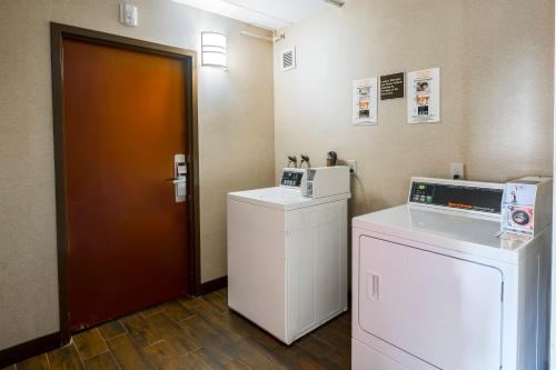 a room with a washer and dryer and a door at Red Roof Inn PLUS+ Boston - Woburn/ Burlington in Woburn