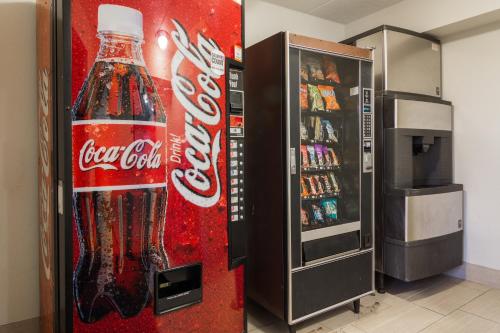 a cocacola bottle vending machine next to a refrigerator at Red Roof Inn Chattanooga - Hamilton Place in Chattanooga