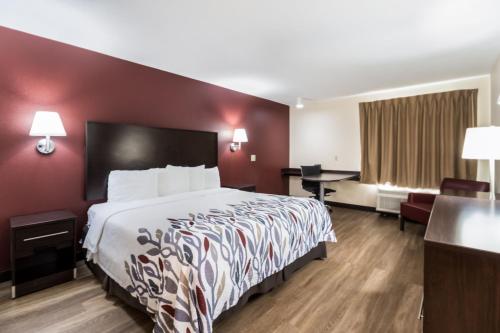 a hotel room with a bed and a desk at Red Roof Inn Murfreesboro in Murfreesboro