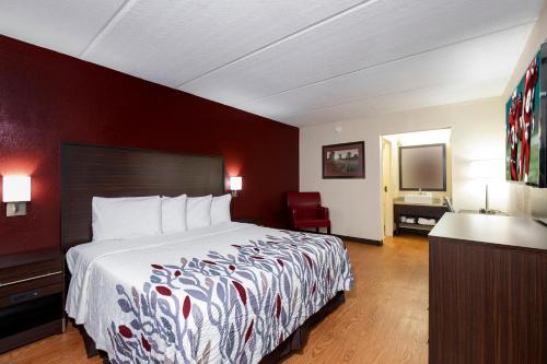 a hotel room with a bed and a desk at Red Roof Inn Kenly - I-95 in Kenly