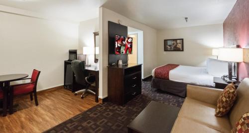 a hotel room with a bed and a desk at Red Roof Inn Oklahoma Airport I 40 W Fairgrounds in Oklahoma City