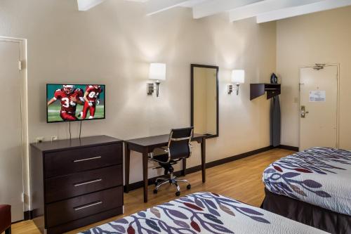 a hotel room with a desk and a bed at Red Roof Inn Richmond, IN in Richmond