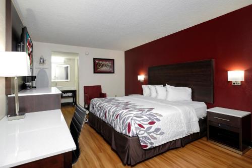 a hotel room with a bed and a bathroom at Red Roof Inn Gadsden in Gadsden