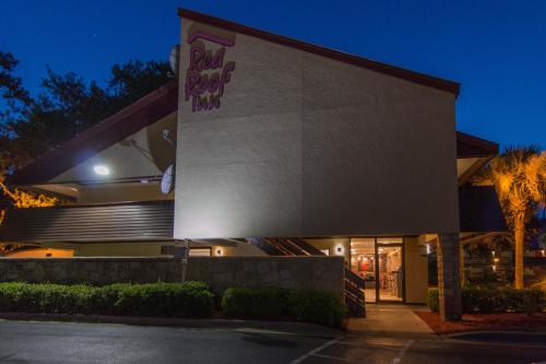 a building with a sign on the side of it at Red Roof Inn Hilton Head Island in Hilton Head Island