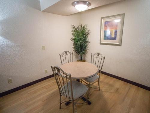 a table and chairs in a room with a potted plant at Red Roof Inn Hilton Head Island in Hilton Head Island