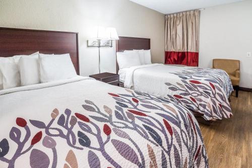 a hotel room with two beds in a room at Red Roof Inn Spartanburg - I-26 in Spartanburg