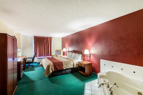 a hotel room with a bed and a bath tub at Red Roof Inn Morehead in Morehead