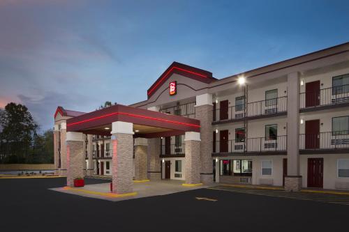 a rendering of a hotel with a gas station at Red Roof Inn PLUS+ Birmingham East – Irondale/Airport in Birmingham