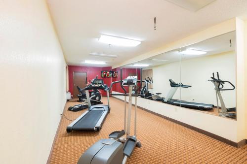a fitness room with treadmills and elliptical machines at Red Roof Inn & Suites Cincinnati North-Mason in Mason