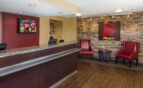 a bar with red chairs and a red rock pizza sign at Red Roof Inn PLUS+ Baltimore-Washington DC/BWI Airport in Linthicum Heights