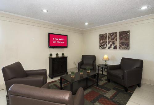 a waiting room with two chairs and a tv at Red Roof Inn Bloomington - Normal/University in Bloomington