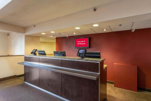 a lobby with a cash counter with a sign on the wall at Red Roof Inn PLUS+ El Paso East in El Paso