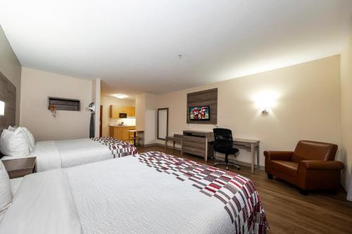 a hotel room with two beds and a desk at Red Roof Inn Panama City in Panama City