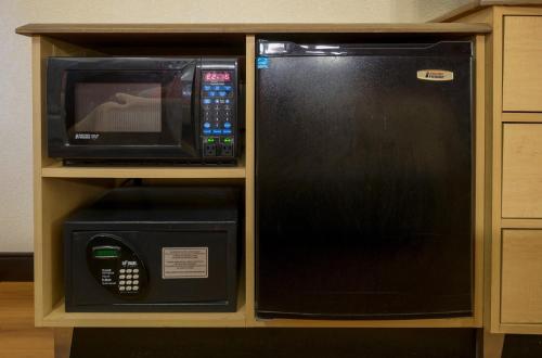 a microwave and a microwave oven in a cabinet at Red Roof Inn Chesapeake Conference Center in Chesapeake