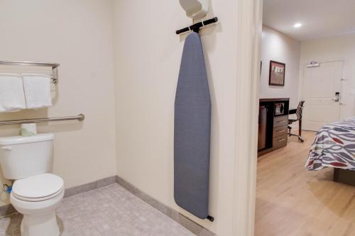a blue tie hanging on a wall in a bathroom at Red Roof Inn Houston - Willowbrook in Houston
