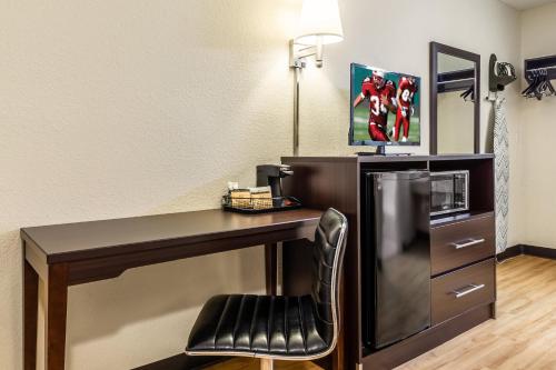 a computer desk with a chair in a room at Red Roof Inn Scottsburg in Scottsburg