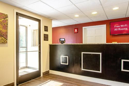 an empty waiting room with a sign that reads fire wait all rooms at Red Roof Inn Scottsburg in Scottsburg