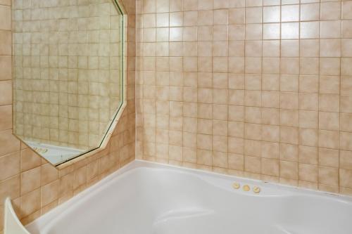 a shower with a bath tub with a glass door at Red Roof Inn Columbus - Taylorsville in Taylorsville
