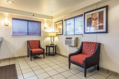 a waiting room with two chairs and a fan at HomeTowne Studios by Red Roof Louisville in Louisville