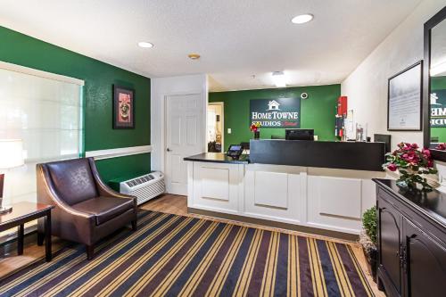a waiting room with a cash register and a chair at HomeTowne Studios by Red Roof Atlanta – Lawrenceville in Lawrenceville