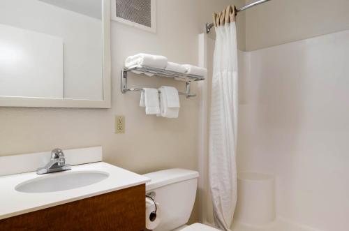 a bathroom with a sink and a toilet and a shower at HomeTowne Studios by Red Roof Denver - Thornton in Thornton