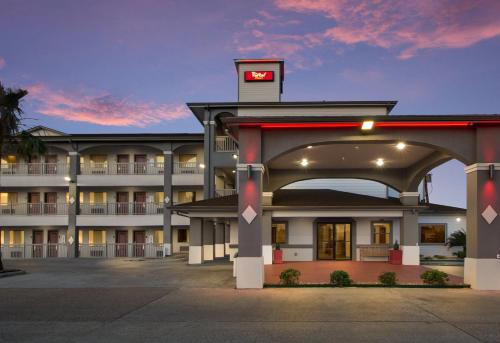 a hotel building with a clock on top of it at Red Roof Inn PLUS + Galveston - Beachfront in Galveston