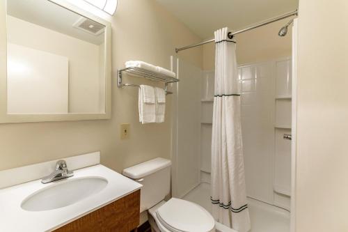 a bathroom with a sink and a toilet and a shower at HomeTowne Studios by Red Roof Austin in Cedar Park
