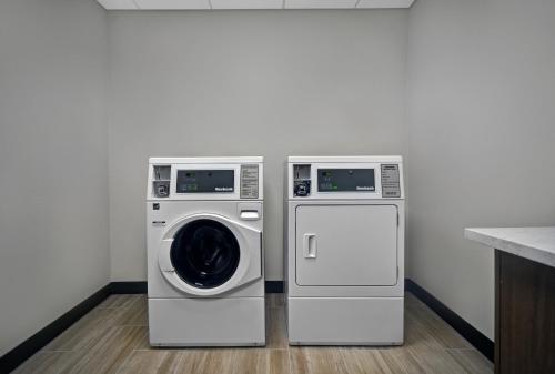 two washing machines sitting next to each other in a kitchen at Holiday Inn Grand Rapids North - Walker by IHG in Walker