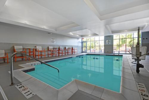 a large swimming pool in a building at Holiday Inn Grand Rapids North - Walker by IHG in Walker