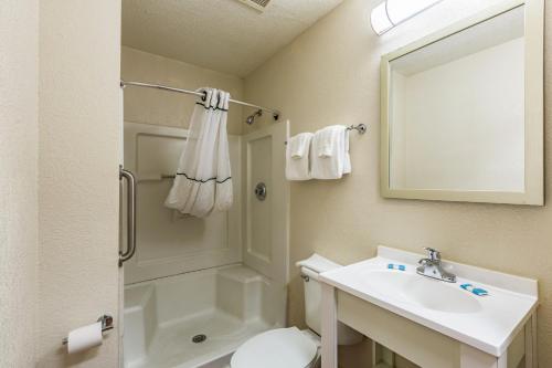 a bathroom with a shower toilet and a sink at HomeTowne Studios by Red Roof Atlanta - Chamblee in Atlanta