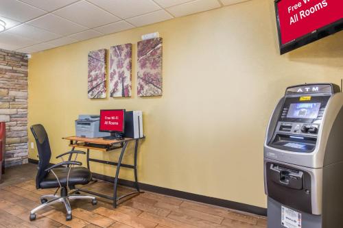 an atm machine in a waiting room with a desk at Red Roof Inn Cincinnati Airport–Florence/ Erlanger in Erlanger