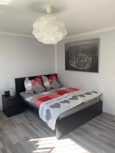 a bedroom with a bed and a pendant light at Sauerlandblick - Appartement & FeWo Wickede in Wickede (Ruhr)