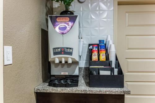 a coffee machine sitting on a counter next to a door at Red Roof Inn Williamsburg in Williamsburg