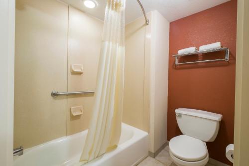 a bathroom with a toilet and a shower at Red Roof Inn & Suites Philadelphia - Bellmawr in Bellmawr