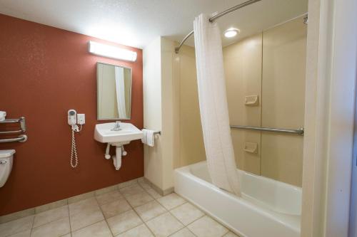 a bathroom with a tub and a sink and a shower at Red Roof Inn & Suites Philadelphia - Bellmawr in Bellmawr