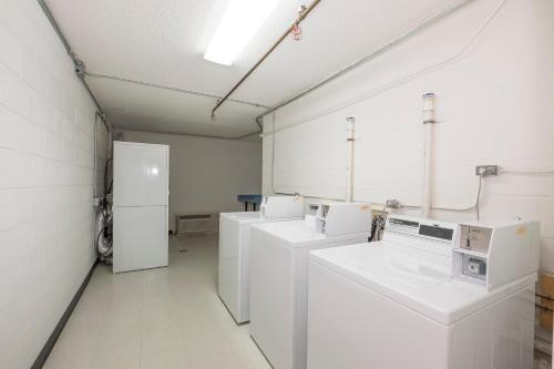 a laundry room with white washers and refrigerators at Red Roof Inn Dumfries-Quantico in Dumfries