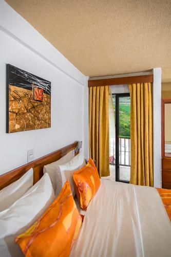 a hotel room with two beds and a window at Cordillera Hotel in Trujillo
