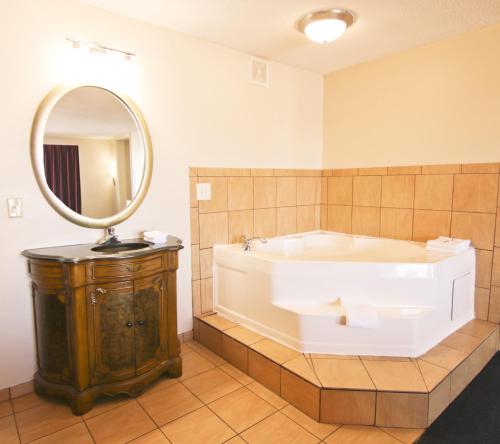 a large bathroom with a tub and a mirror at Red Roof Inn Somerset, KY in Somerset
