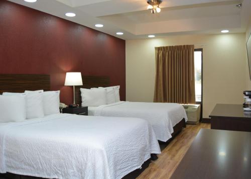 a hotel room with two beds and a window at Red Roof Inn PLUS+ & Suites Chattanooga - Downtown in Chattanooga